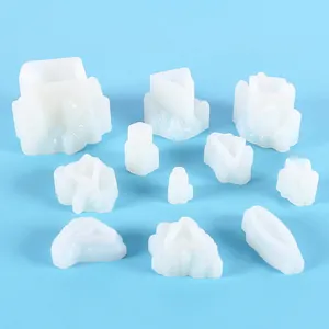 Detailed view of multiple white silicone resin molds in various crystal cluster shapes