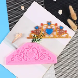 Detail view showing a pink heart crown silicone lace mold with a finished resin sample piece