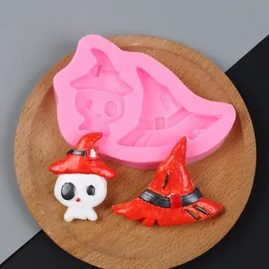 Macro view of pink silicone mold with finished Halloween skull and wizard hat crafts