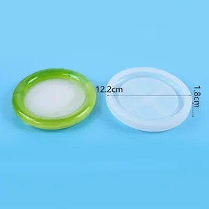 Close-up of round tray silicone mold and green resin coaster with dimensions and weight