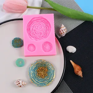 Detailed view of pink floral silicone mold with finished resin flower pieces and seashells