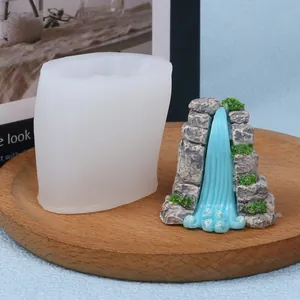 Close-up of DIY rockery waterfall silicone mold with finished miniature landscape candle