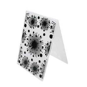 Detailed close-up view of starburst pattern on transparent plastic folding embossing folder