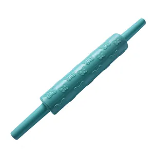 Detail view of embossed butterfly pattern on teal plastic fondant rolling pin