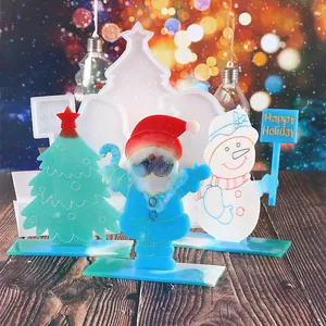 Detailed view of DIY Christmas resin molds and finished ornaments with Santa and Snowman