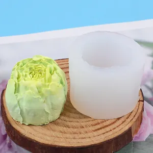 Detail view of a silicone mold and its cabbage-shaped green fondant output on a wood base