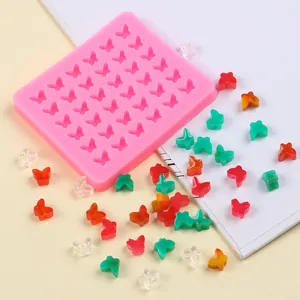 Moule en silicone papillon rose avec de mini papillons colorés pour décoration de gâteau