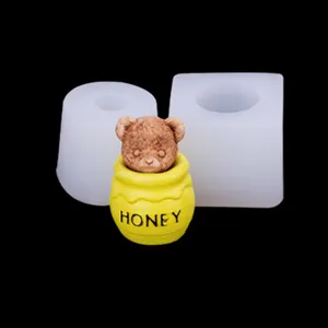 Detailed view of white silicone molds alongside a cute teddy bear honey pot ornament