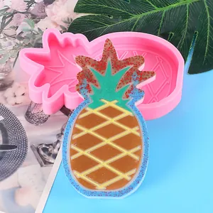 Detailed close-up of a pineapple silicone mold and a finished glittery resin product