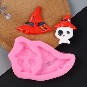 Close-up detail of pink Halloween wizard hat and skull silicone mold for DIY cake decoration
