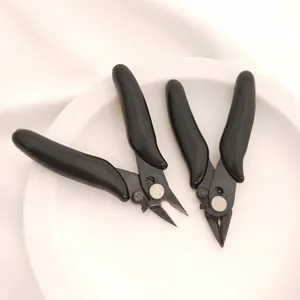 Macro view of professional black jewelry making pliers on a display plate