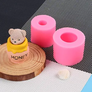 Close-up of pink silicone molds and finished 3D teddy bear honey pot ornament candle