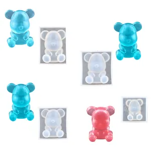 Detailed view of mini bear silicone molds with finished blue and pink resin bears