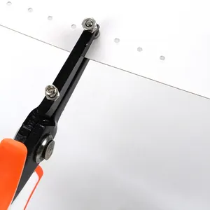 Close-up detail of a manual jewelry hole punch tool punching precise holes in paper.