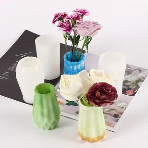 Detail showing DIY silicone molds alongside finished resin flower vases with roses