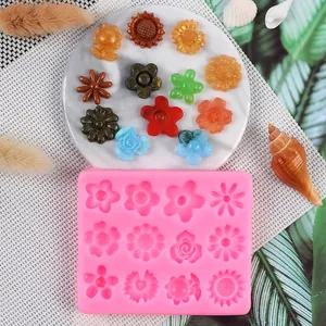 Detail shot of pink silicone mold with finished 3D resin flower samples on a marble tray.