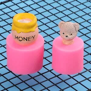 Detailed view of teddy bear and honey pot models made with pink silicone molds