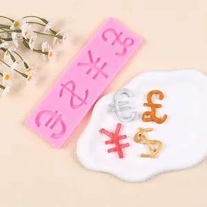 Macro view of pink silicone mold with dollar euro pound yen currency symbol decorations