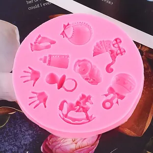 Detailed macro view of pink baby themed silicone mold with various cute infant shapes.