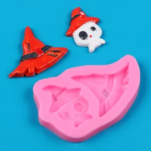 Detail view of pink Halloween silicone mold with wizard hat and skull finished items