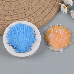 Close-up detail of an ocean themed seashell silicone mold and a finished resin piece.