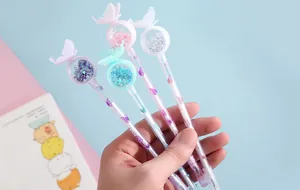 Detailed view of four colorful butterfly sequin gel pens held in hand