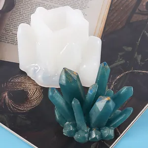 Close-up of white silicone crystal cluster mold and teal resin art piece for DIY crafts