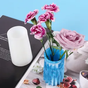 Close-up detail of DIY crystal resin vase silicone mold and a finished blue floral holder