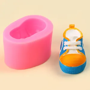 Detailed view of pink silicone mold and finished 3D baby sneaker for DIY plaster crafts