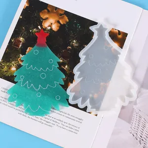 Detail of translucent silicone mold and finished green resin Christmas tree ornament