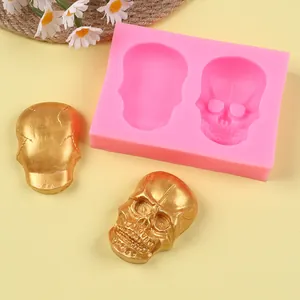 Macro view of skull silicone mold featuring golden resin casts on a soft yellow background