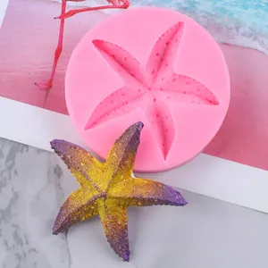 Detail view showing a pink starfish silicone mold alongside a finished model