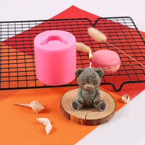 Detailed view of pink silicone mold and finished 3D teddy bear candle for aromatherapy