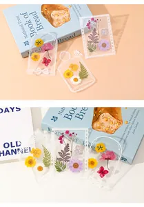 Macro detail of transparent DIY bottle stickers featuring colorful pressed dried flowers