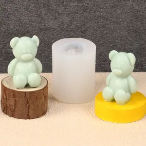 Close-up of silicone bear candle mold and finished mint green wax figures