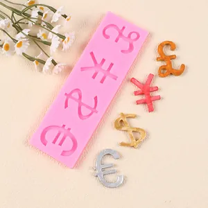 Detail view of currency symbol silicone mold with finished gold and silver fondant pieces