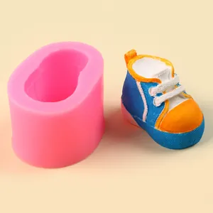 Detail of pink silicone mold and miniature blue baby shoe sculpture
