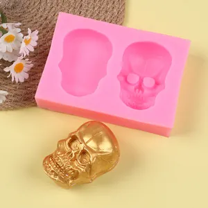 Detailed view of pink skull silicone mold and a finished golden skull craft for DIY.