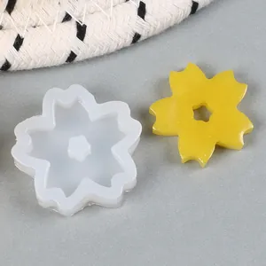 Detailed view of flower silicone mold with a yellow glittery resin casting piece.