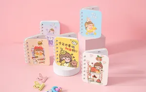 Collection of cute mini spiral notebooks with colorful cartoon girl illustrations on pink backdrop.