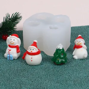Detailed view of DIY Christmas silicone mold with finished snowman and tree figurines.