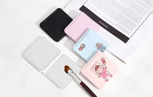 Close-up view of various cute pastel candy-colored portable double-sided makeup mirrors