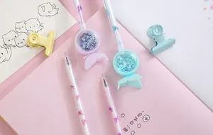 Detailed view of cute gel pens with heart-shaped sequins and butterfly decorative elements