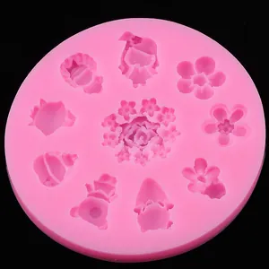 Detailed view of pink silicone mold with various floral and rose patterns for fondant