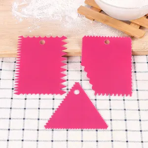 Set of three pink plastic cake scrapers with various serrated edges for DIY baking.