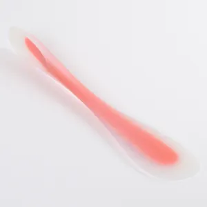 Detail view of a pink translucent silicone spatula for baking and cream smoothing.