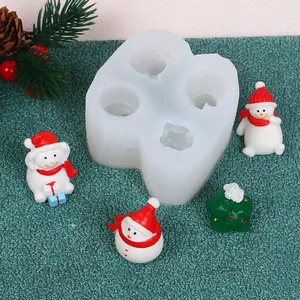 Detailed view of white Christmas silicone mold with finished miniature snowmen and tree
