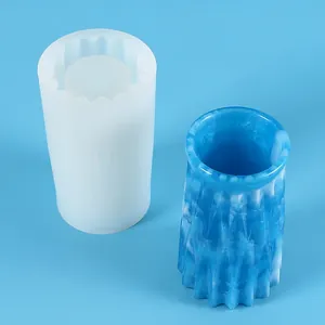 Macro view of silicone mold for DIY resin vase beside finished blue marbled pen holder