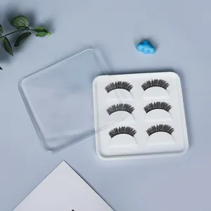 Detail of white silicone eyelash storage box with 3 pairs of lashes and clear lid