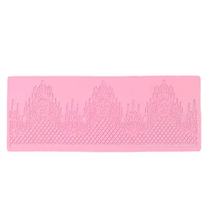 Detailed macro view of a pink silicone lace border mold for fondant cake decorating.